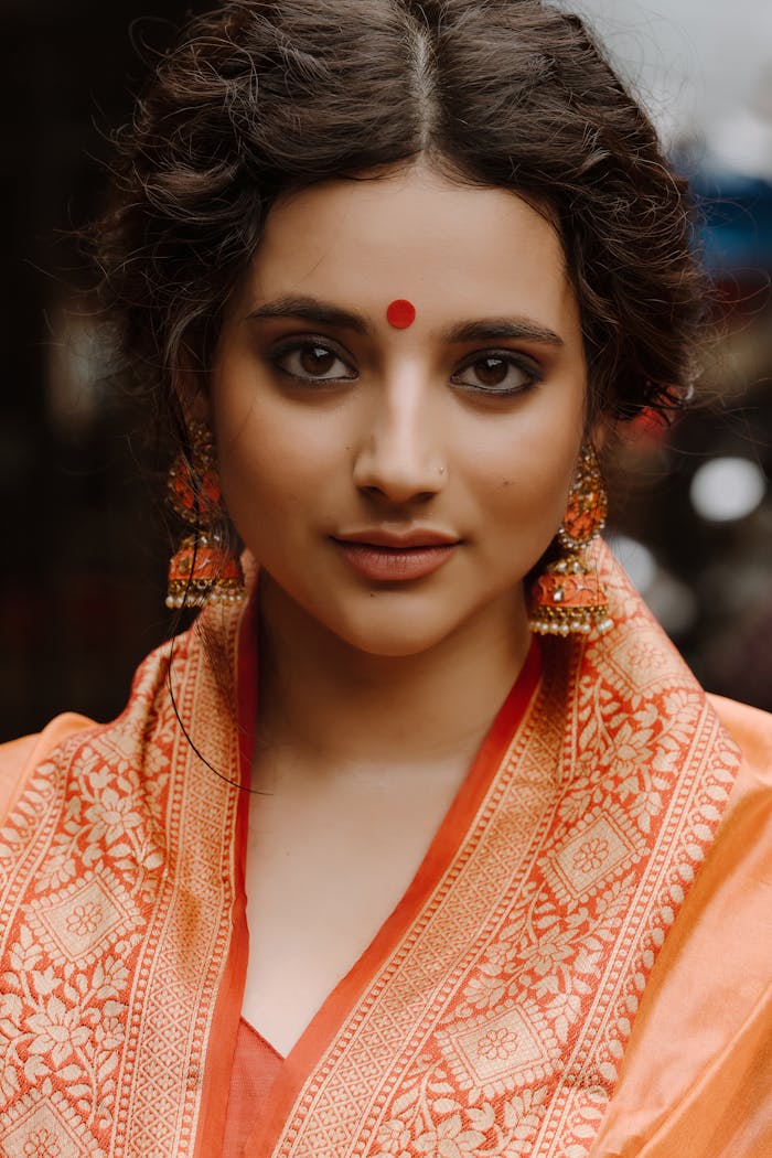 Close-up portrait of a woman wearing traditional Indian attire.